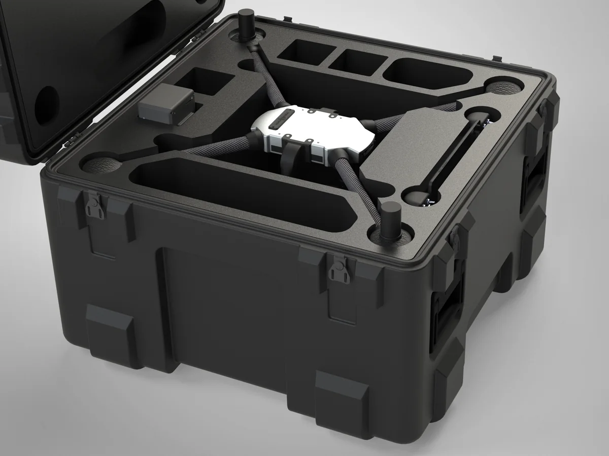 A rendered view of a folded quadrotor and its battery seated in a custom foam-cut transit case.